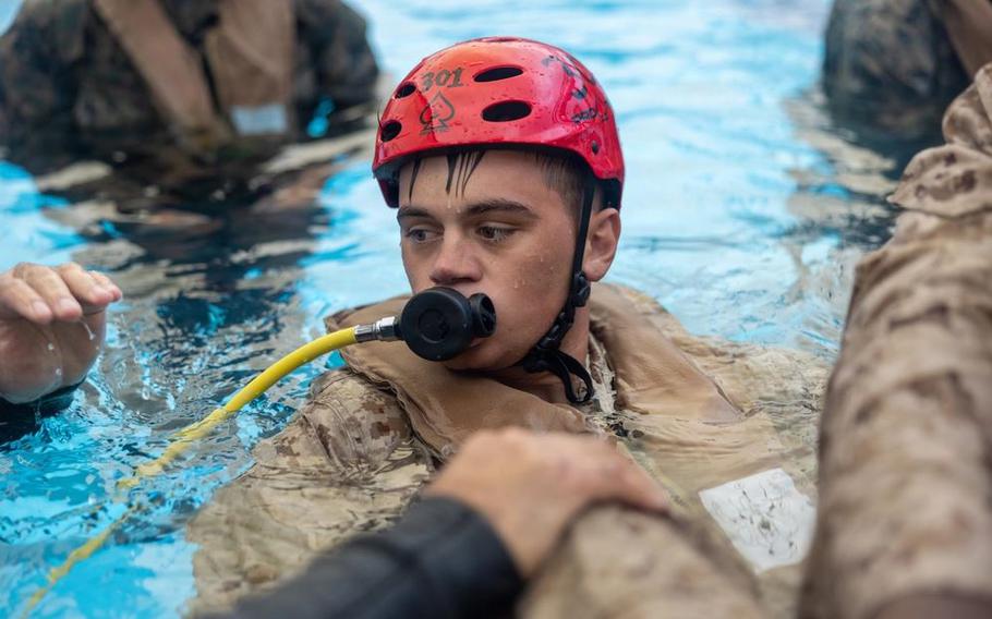U.S. Marine Corps Lance Cpl. Dylan Ries participates in underwater egress training at the Hansen Aquatics Center on Camp Hansen, Okinawa.